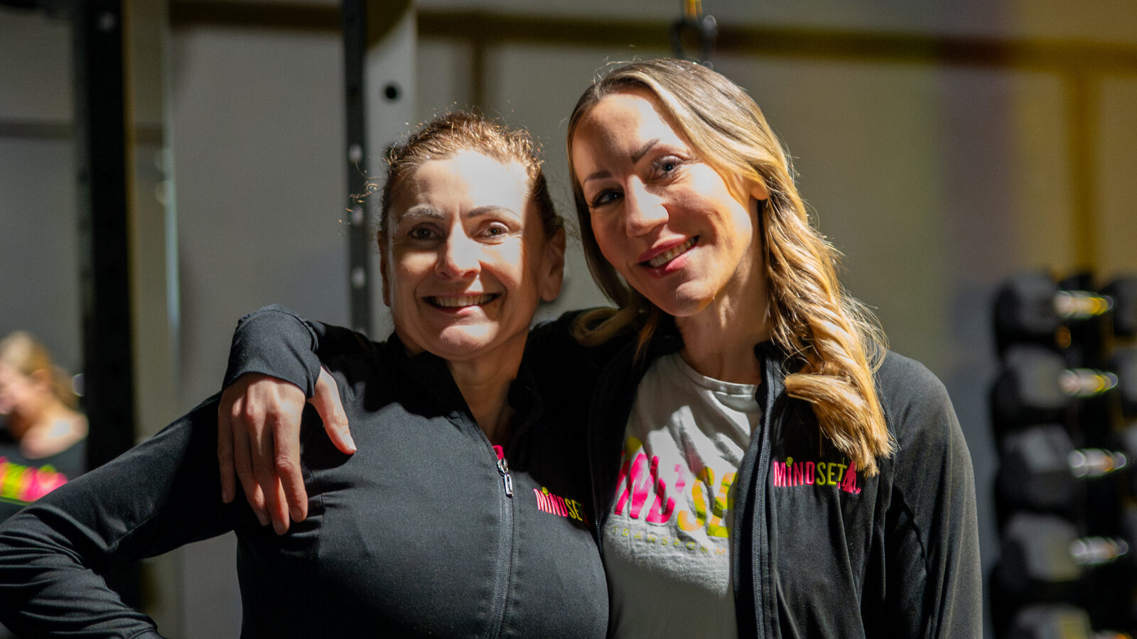 A Mindset member in her sixties with founder Carrie in the studio in Southampton, after a small-group strength session