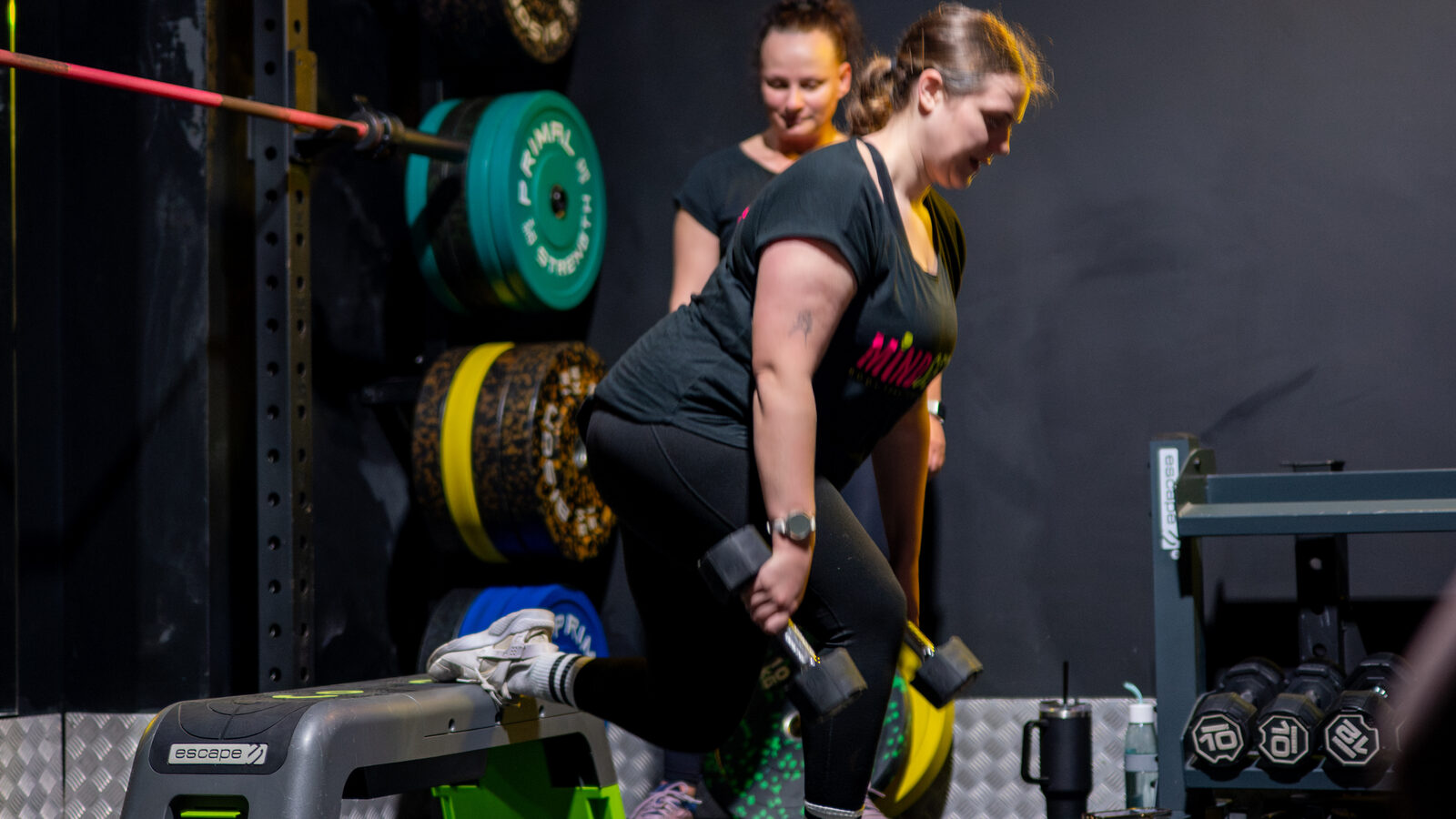 A Mindset member loading her legs with dumbbells during a small-group session in Southampton